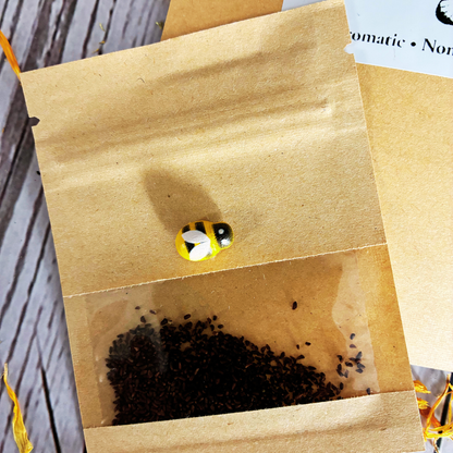 Plant Thyme evening pollinator Sprinkles packaging with white evening primrose seeds on a wooden surface with dried flowers for pollinator gardens